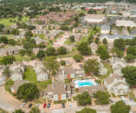 A bird's eye view of Woodland oaks with roads, and a pool.