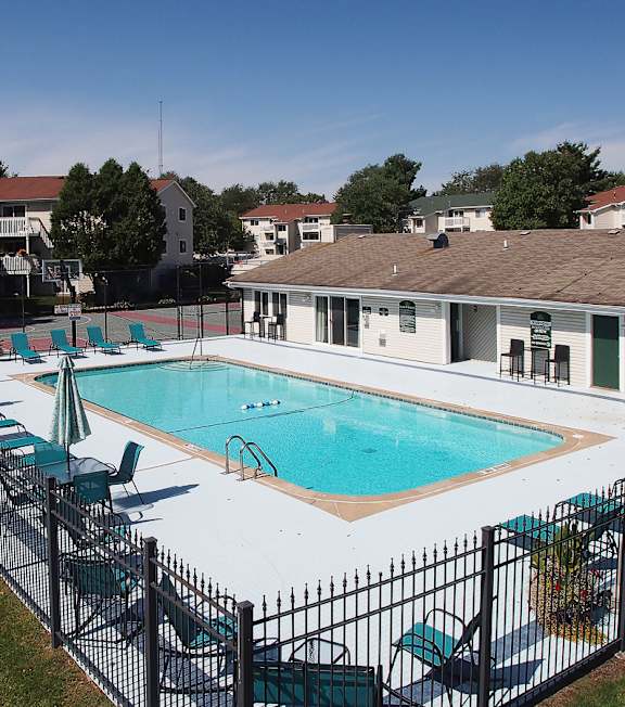 A black fence surrounds a small pool.