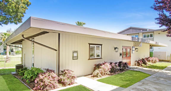 a house with a sidewalk and grass in front of it