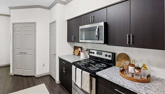 A kitchen with a stove top oven and a microwave above it.