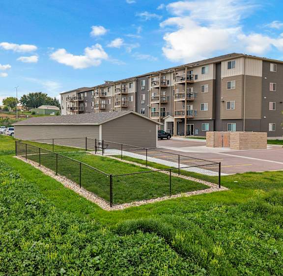 A residential area with apartment buildings and a small house.