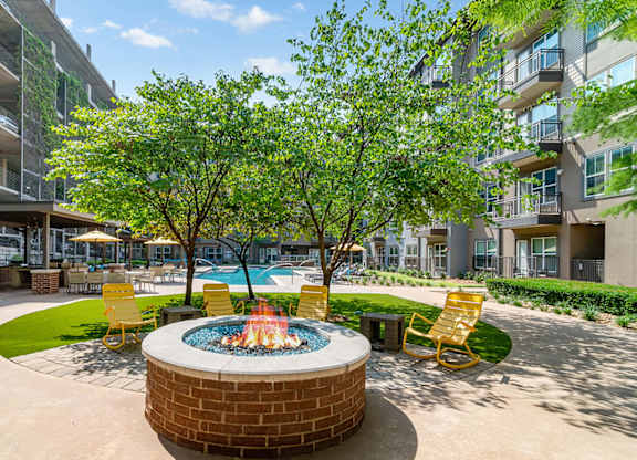 A small pool surrounded by a hot tub and chairs.