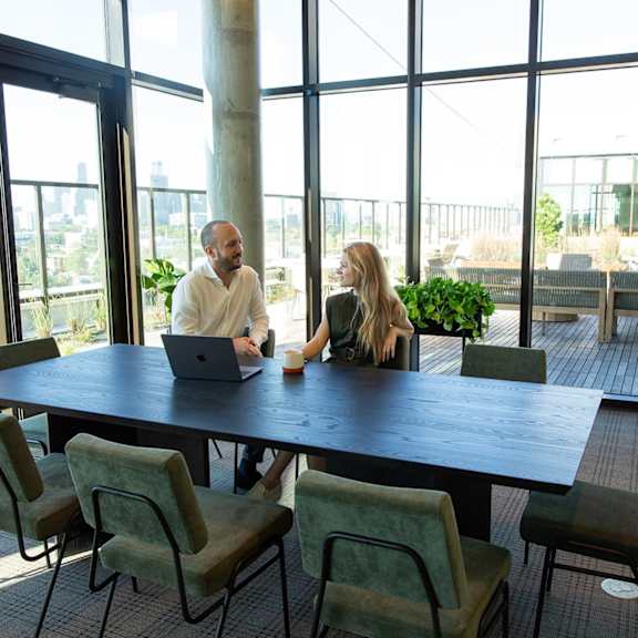 Two People sitting at conference room table2 at Scout Living, powered by Placemakr, Atlanta, 30308