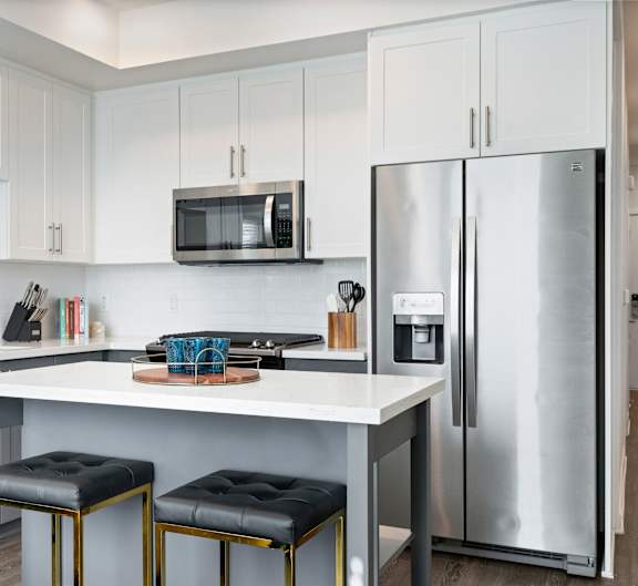 a kitchen with stainless steel appliances and a white counter top