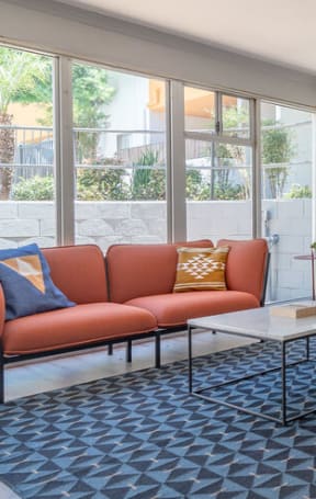 a living room with a couch and a table at The Flats on Addison, California, 91423