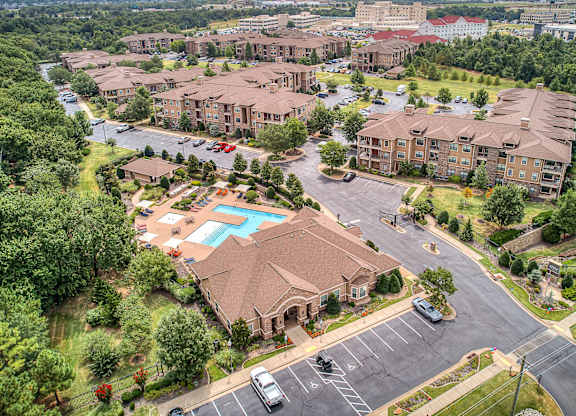 A bird's eye view of a residential complex with a swimming pool.