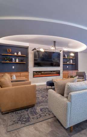 A modern living room with a fireplace and a large TV.