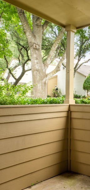 a covered porch with a house in the background at Summit Ridge Apartments, Temple, 76502