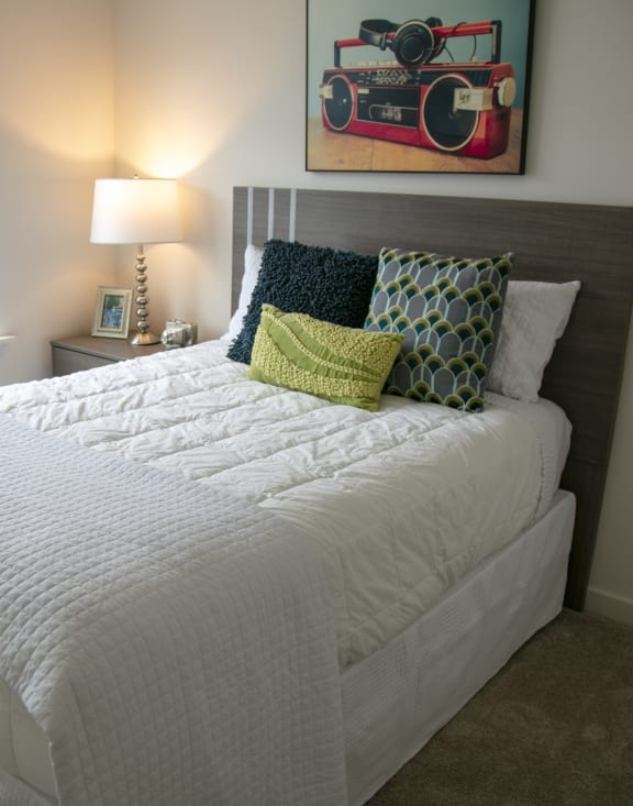 a bedroom with a large bed and a window at Enclave Crystal Lake Townhomes and Apartments, Illinois