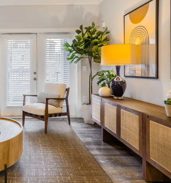 a living room with a table and chairs and a door