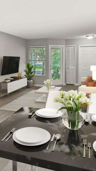 Dining room table with plates and a vase of flowers on top of it at Aqua Bay Apartments in Naples, FL 34116