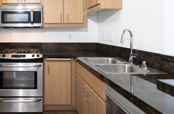 a kitchen with stainless steel appliances and wooden cabinets