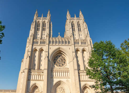 people standing in front of the cathedral of notre dame