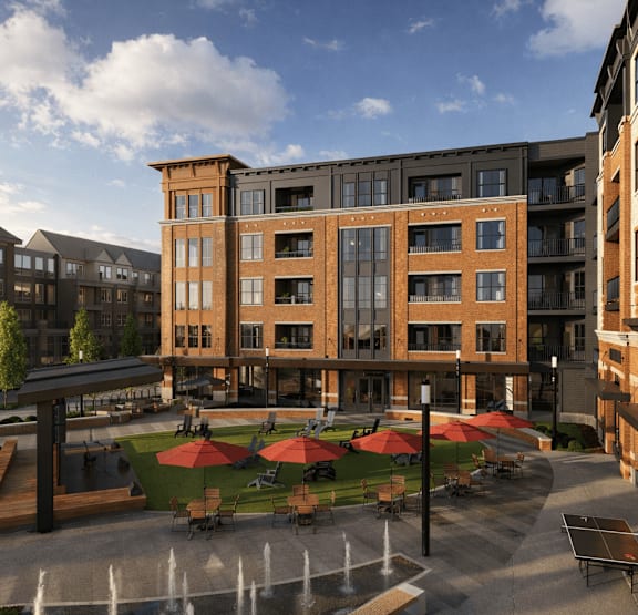 A modern building with a courtyard and seating area.