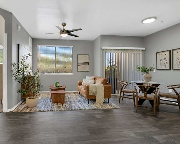 A living room with a ceiling fan and a couch.
