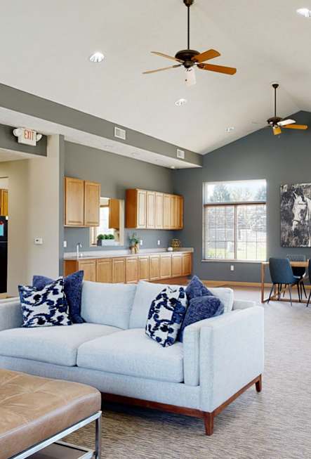 a great room with a couch and a table in front of a fireplace