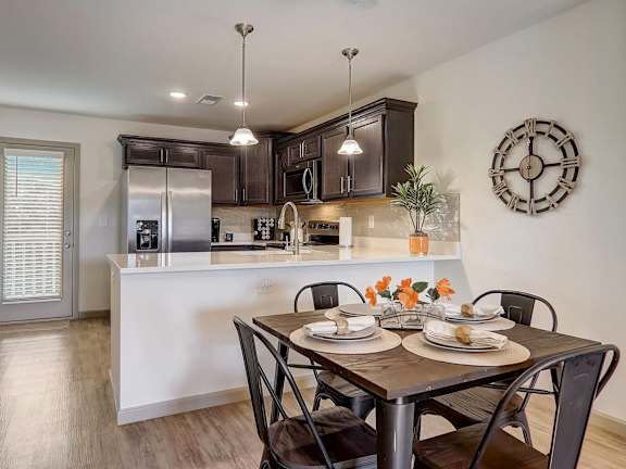 an open kitchen and dining room with a table and chairs
