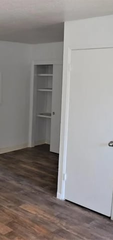 an empty living room with white walls and a wood floor