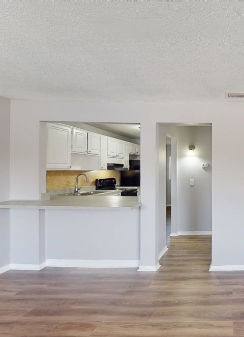 an empty living room and kitchen at Lakeland Manor Apartments