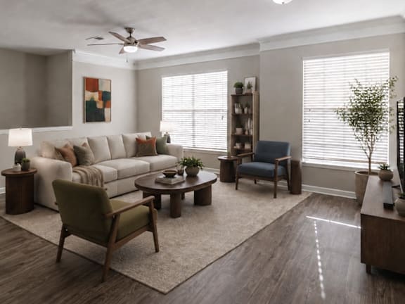 A living room with a white ceiling fan and a grey couch.