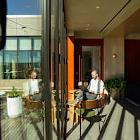 Man is sitting at table in a room at Scout Living, powered by Placemakr, Atlanta