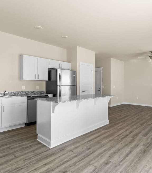 an open kitchen and living room with a counter top island and at Hillcrest Village, Arkansas, 72762