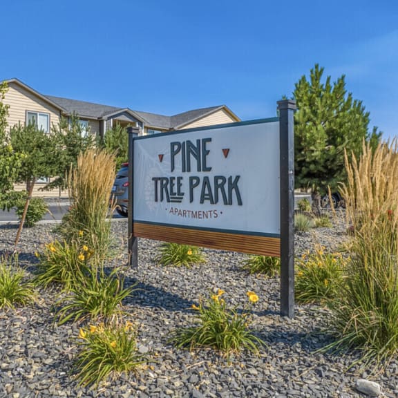 Pine Tree Park entrance sign surrounded by landscaping at Pine Tree Park Apartments in Kennewick at Pine Tree Park, Kennewick