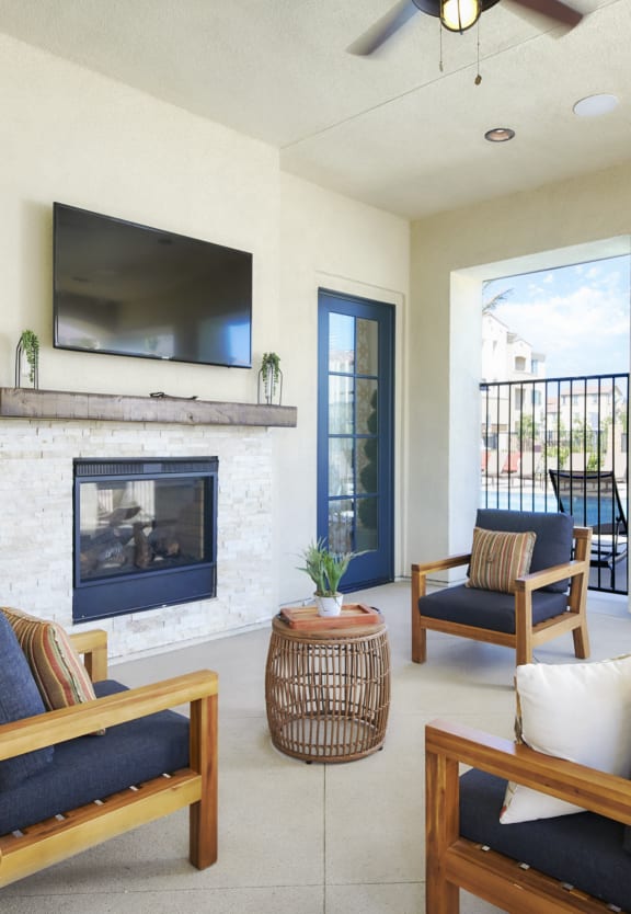 community area seating with tv and fireplace at Mitchell Place Apartments in Murrieta, California