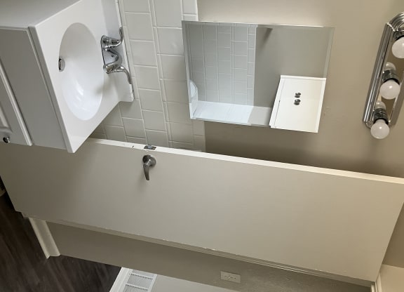 an overhead view of a bathroom with a sink and a mirror