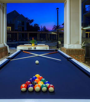a blue pool table with a bunch of balls on it at Canopy at Ginter Park Apartments, Richmond, VA, 23227