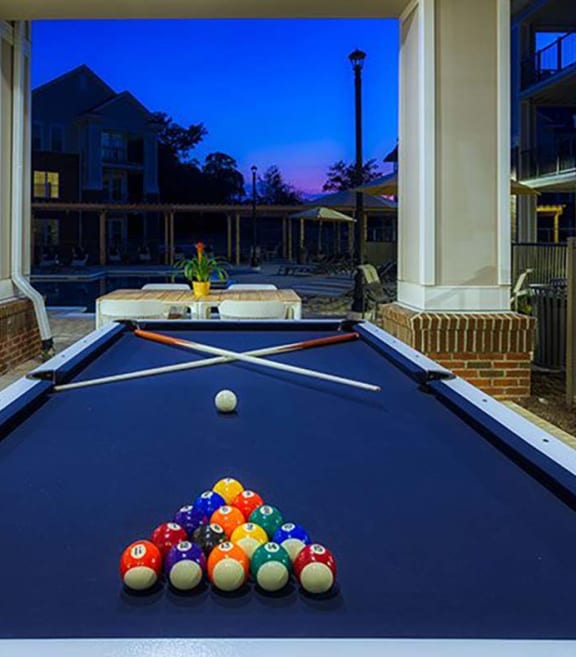 a blue pool table with a bunch of balls on it at Canopy at Ginter Park Apartments, Richmond, VA, 23227