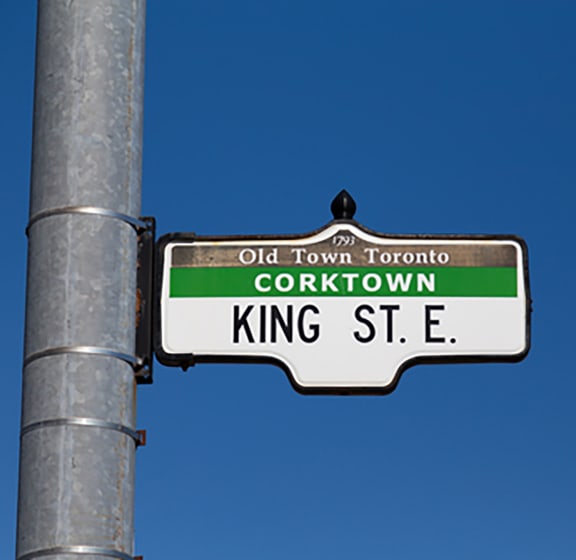 a street sign on a pole in front of a blue sky
