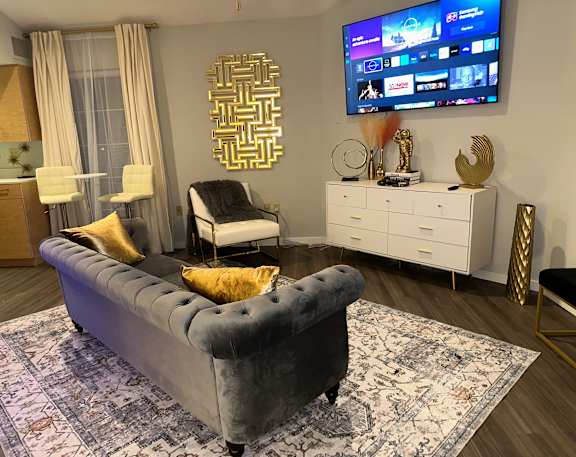Renovated apartment living room with vinyl plank flooring at The Haven at Craigshire