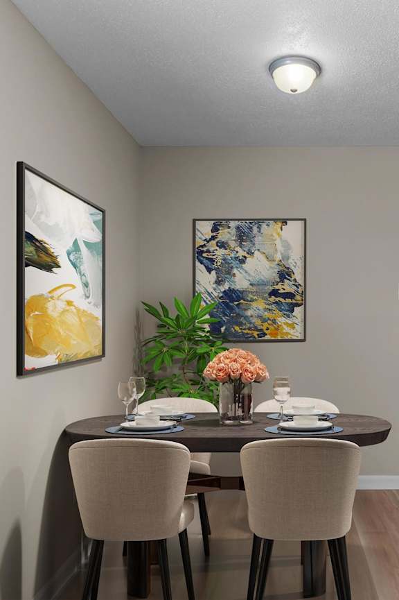 A dining room with a table set for two and a refrigerator to the side.