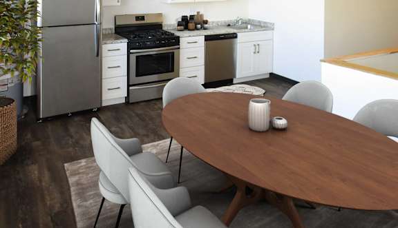 A modern kitchen with a dining table and chairs.