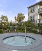 a hot tub with a fence in the background at Aspire Corona, Corona, 92882