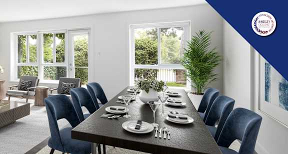 A dining room with a large table set for a meal.