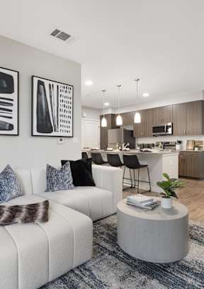 A modern living room with a white couch and a coffee table.