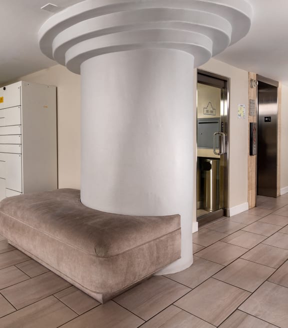 a lobby with a large pillar in the middle of it