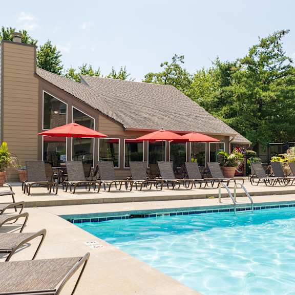 The pool area at Skyler Ridge Apartments, featuring clear blue water and plenty of lounge chairs for residents to enjoy.