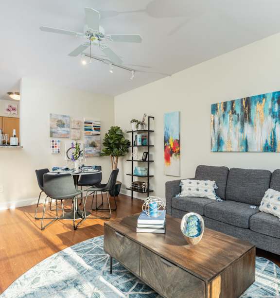 A living room with a grey couch and a wooden coffee table.