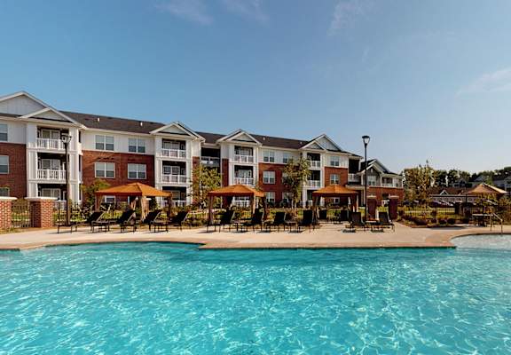 Pool With Cabanas and Chairs