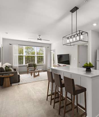 A modern kitchen with white cabinets and a large island.