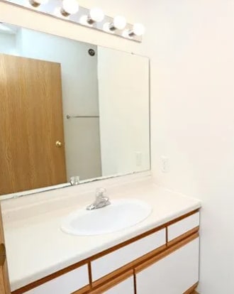 A white toilet sits in a bathroom next to a sink.