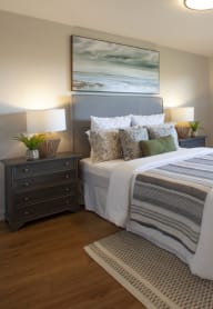 a bedroom with a bed and a chair in a 555 waverly unit