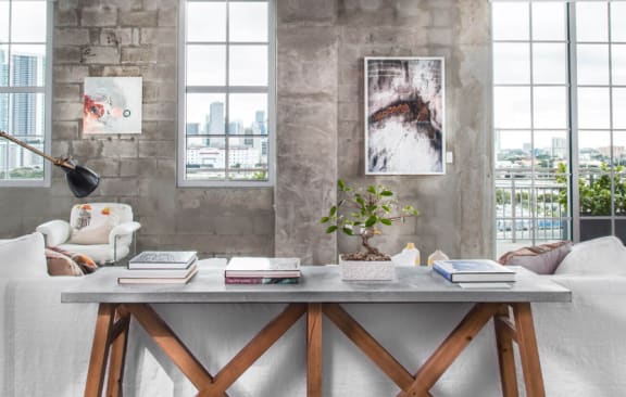 a living room with a white couch and a table with books