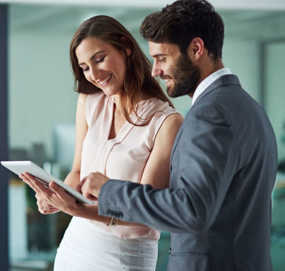a woman talking to a man in an office