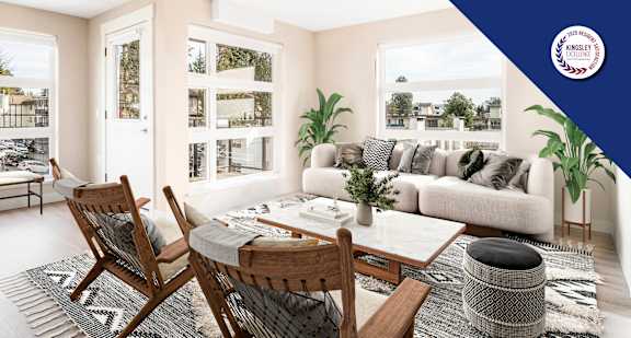 A modern living room with a large window overlooking a garden.