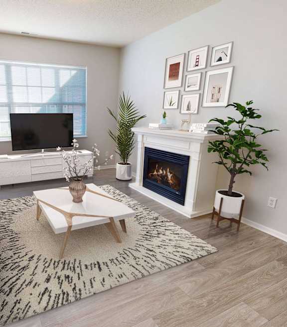 A living room with a grey couch, a coffee table, a fireplace, and a TV.