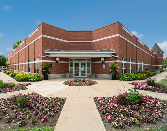 the front of a brick apartment building with steps leading up to the front door